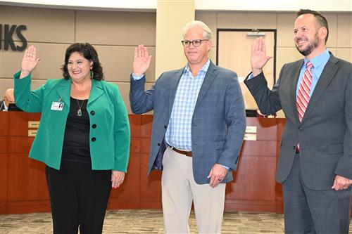 from left, new cfisd trustees dr. natalie blasingame, lucas scanlon and scott henry take the oath of office on dec. 9, 2021.